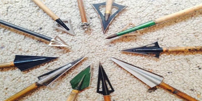 a variety of crossbow broadheads lying on the floor