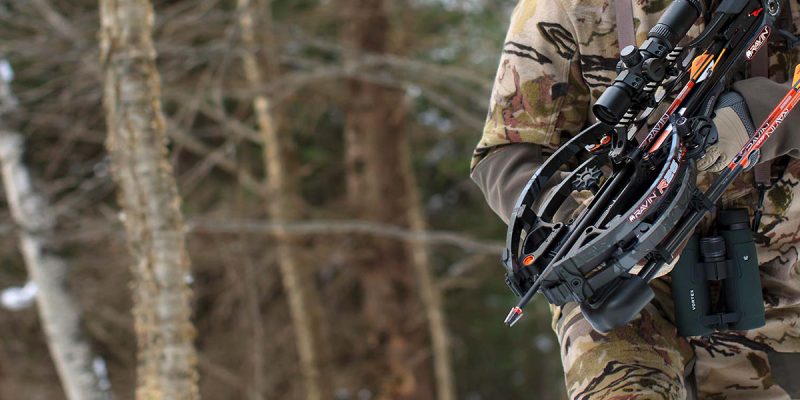 Man hunting in woods with Ravin crossbow